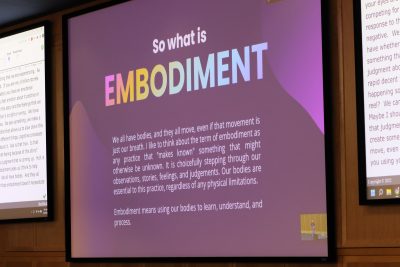 A purple slide depicts the word 'Embodiment' in rainbow letters with a text description of the term during Caro Murphy's keynote presentation in ITE C80